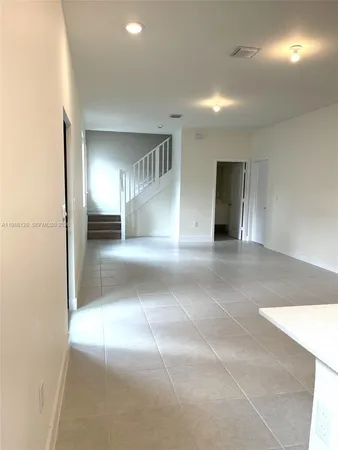 a kitchen with stainless steel appliances granite countertop a sink a stove a microwave a counter top and cabinets