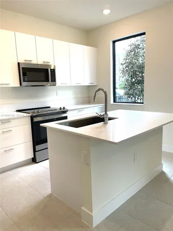 a kitchen with a stove and a microwave