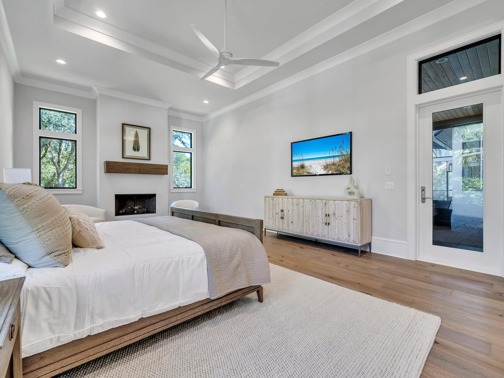 3526 Burnt Pine Lane Miramar Beach, FL 32550 - Photo 27 of 49 a spacious bedroom with a large bed a fireplace and dresser