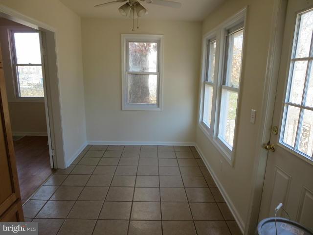 7604 North Point Road Baltimore, MD 21219 - Photo 4 of 13 an empty room with windows and entrance