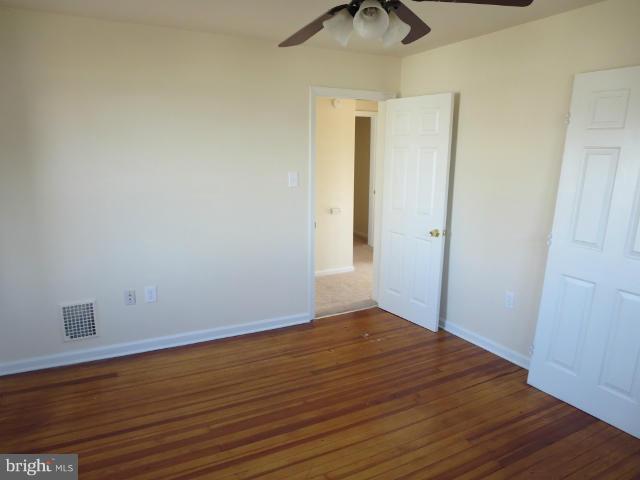 7604 North Point Road Baltimore, MD 21219 - Photo 8 of 13 a view of an empty room with wooden floor