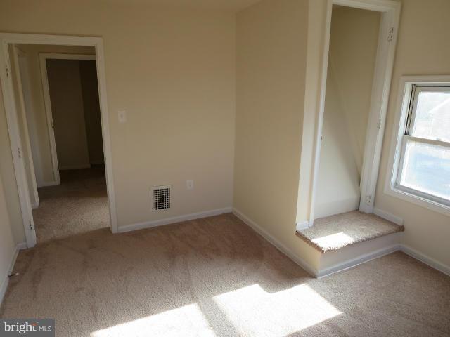 7604 North Point Road Baltimore, MD 21219 - Photo 10 of 13 an empty room with windows
