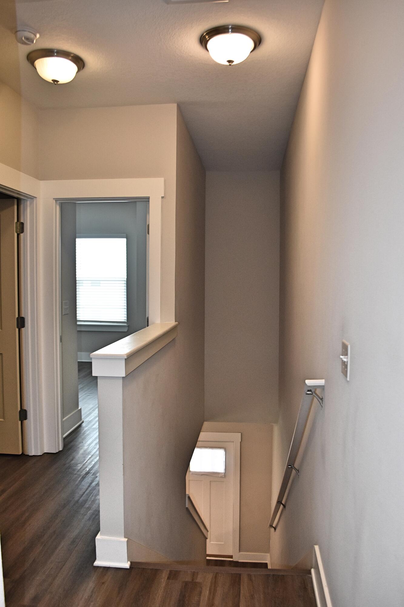 242 North Sand Palm Road Freeport, FL 32439 - Photo 12 of 34 a view of a hallway with wooden floor and staircase