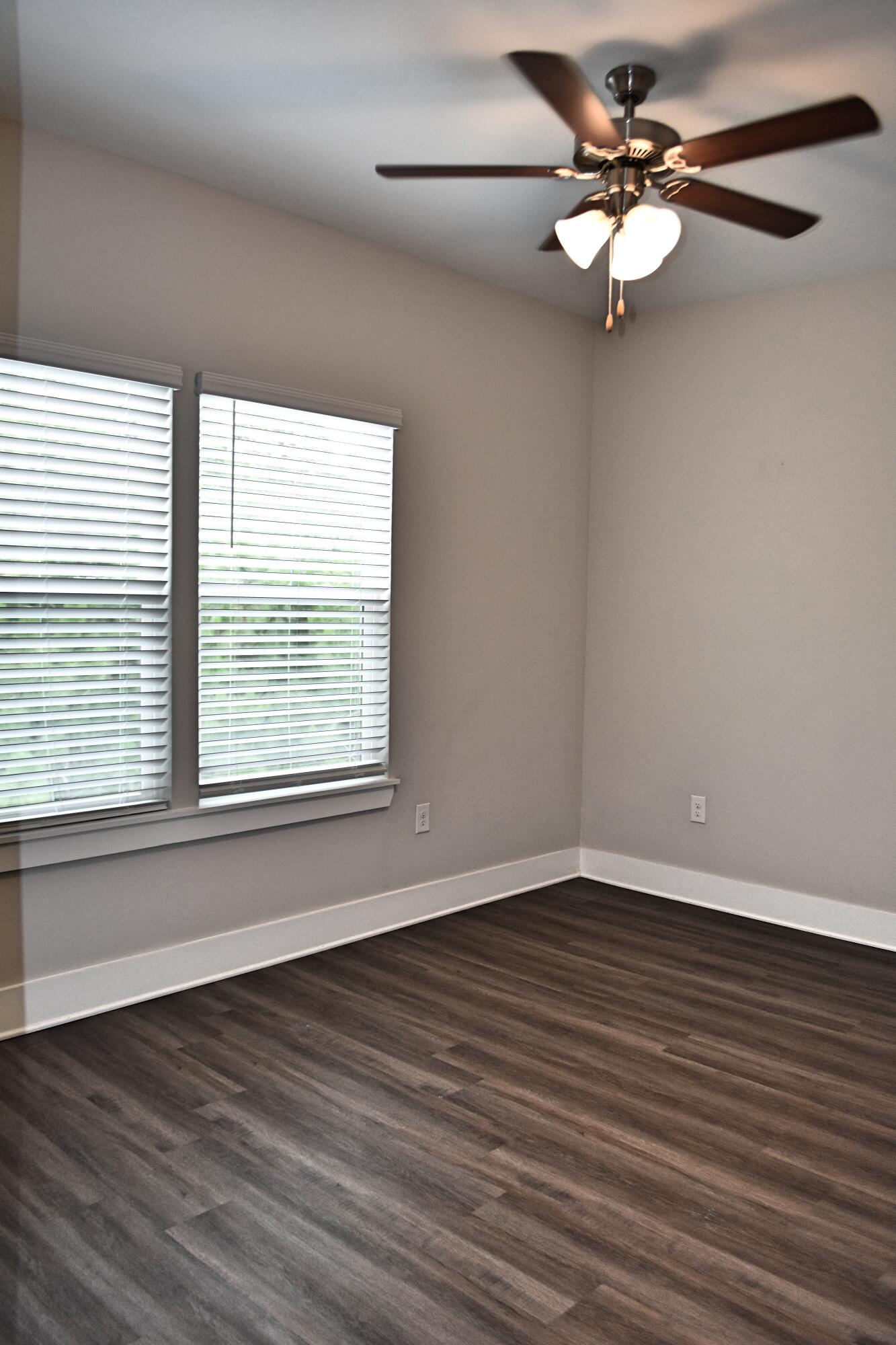 242 North Sand Palm Road Freeport, FL 32439 - Photo 14 of 34 a view of an empty room with wooden floor and a window