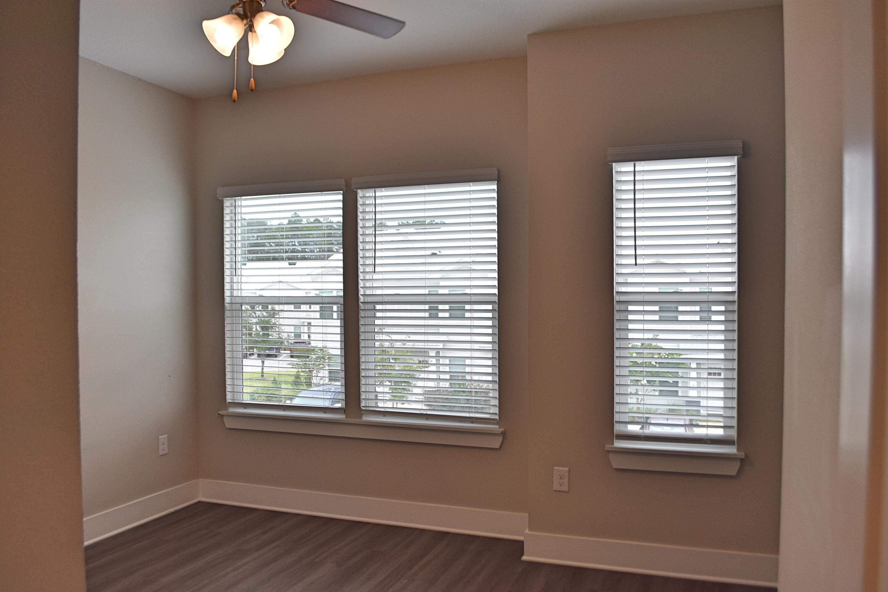 242 North Sand Palm Road Freeport, FL 32439 - Photo 19 of 34 an empty room with wooden floor and windows