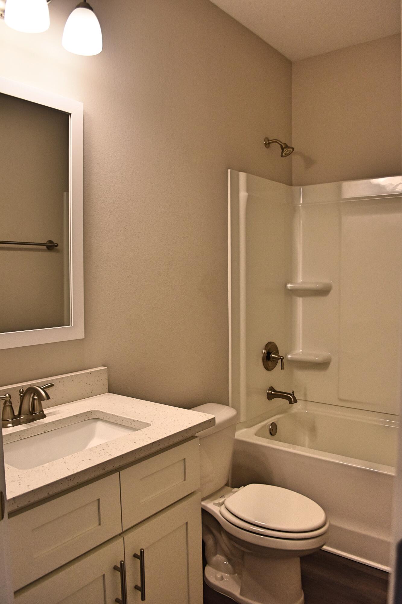 242 North Sand Palm Road Freeport, FL 32439 - Photo 22 of 34 a bathroom with a granite countertop sink toilet and shower