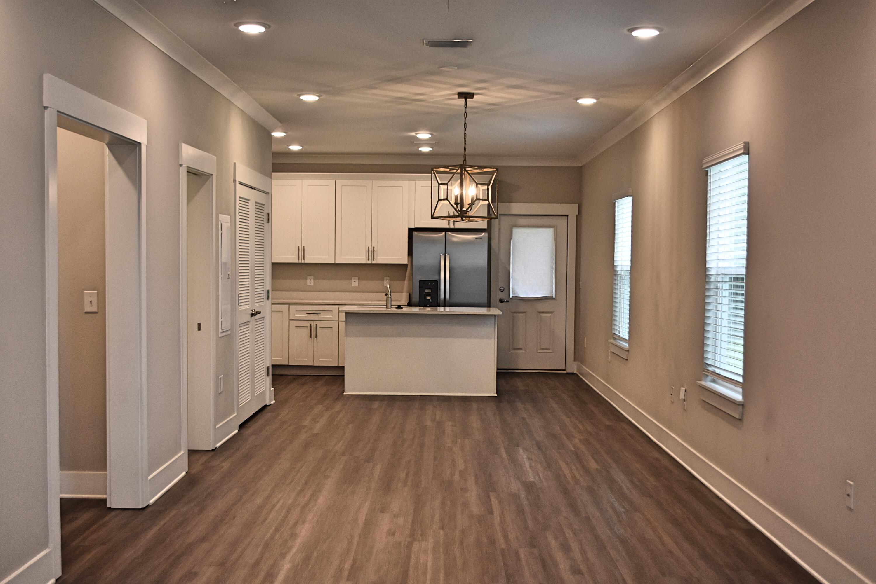 242 North Sand Palm Road Freeport, FL 32439 - Photo 7 of 34 a kitchen with kitchen island stainless steel appliances a refrigerator and a sink