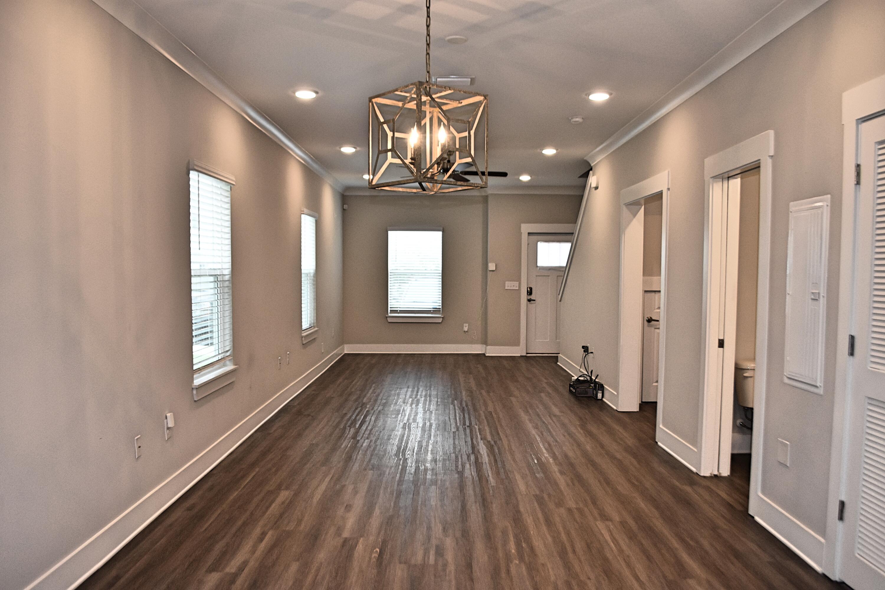 242 North Sand Palm Road Freeport, FL 32439 - Photo 8 of 34 a view of an empty room with wooden floor and a window