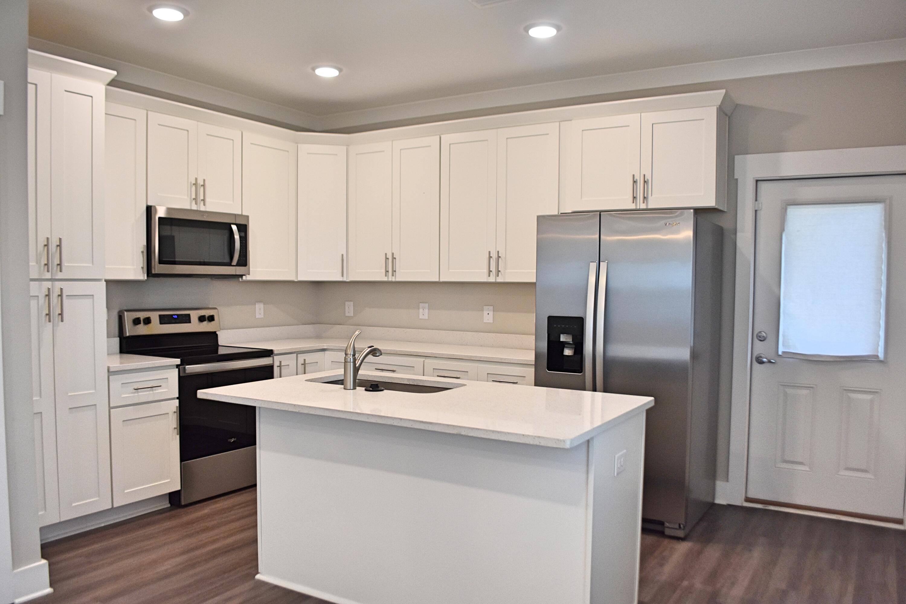 242 North Sand Palm Road Freeport, FL 32439 - Photo 9 of 34 a kitchen with a refrigerator sink and microwave