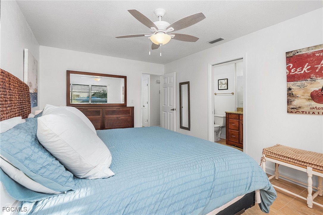 1120 Southeast 46th Street, Unit 2B Cape Coral, FL 33904 - Photo 16 of 26 a bedroom with a large bed and furniture