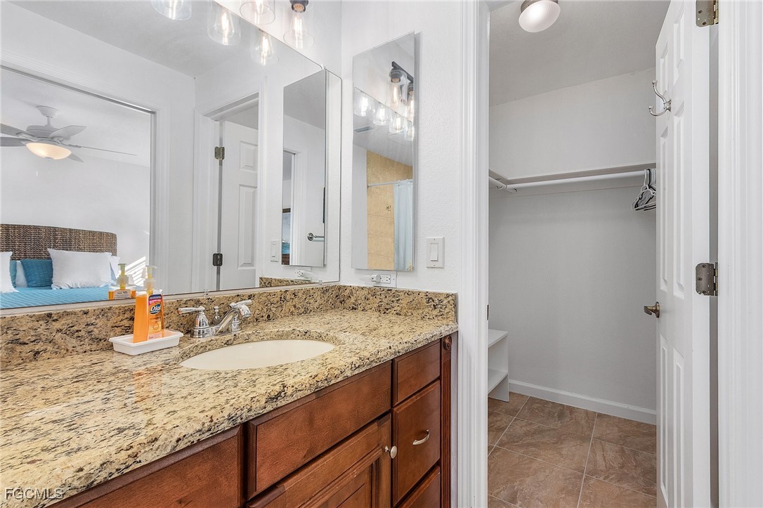 1120 Southeast 46th Street, Unit 2B Cape Coral, FL 33904 - Photo 18 of 26 a bathroom with a granite countertop sink and a mirror