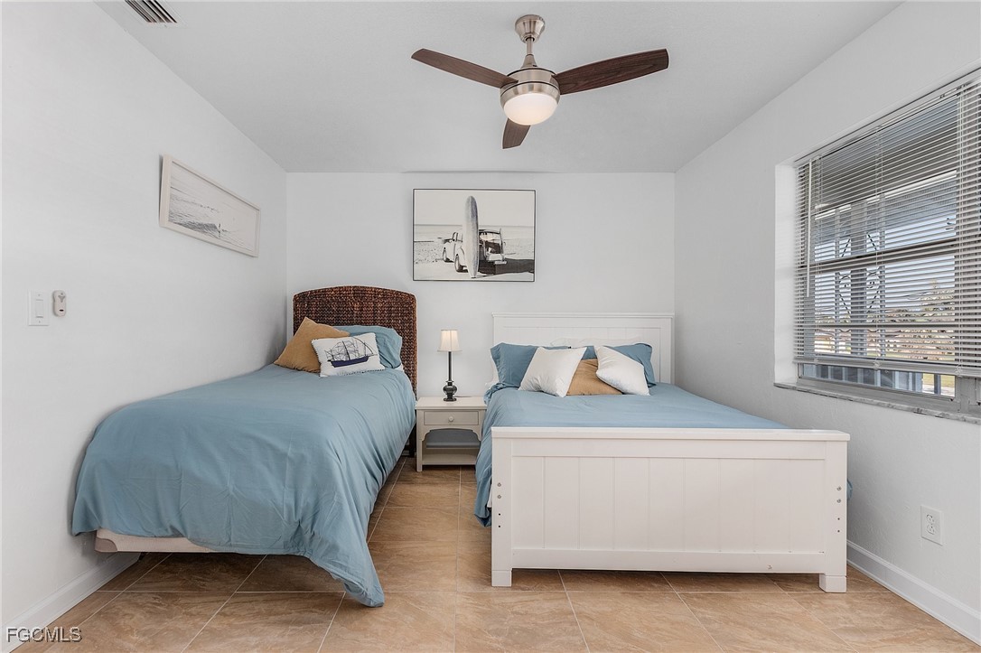 1120 Southeast 46th Street, Unit 2B Cape Coral, FL 33904 - Photo 20 of 26 a bedroom with a bed and window