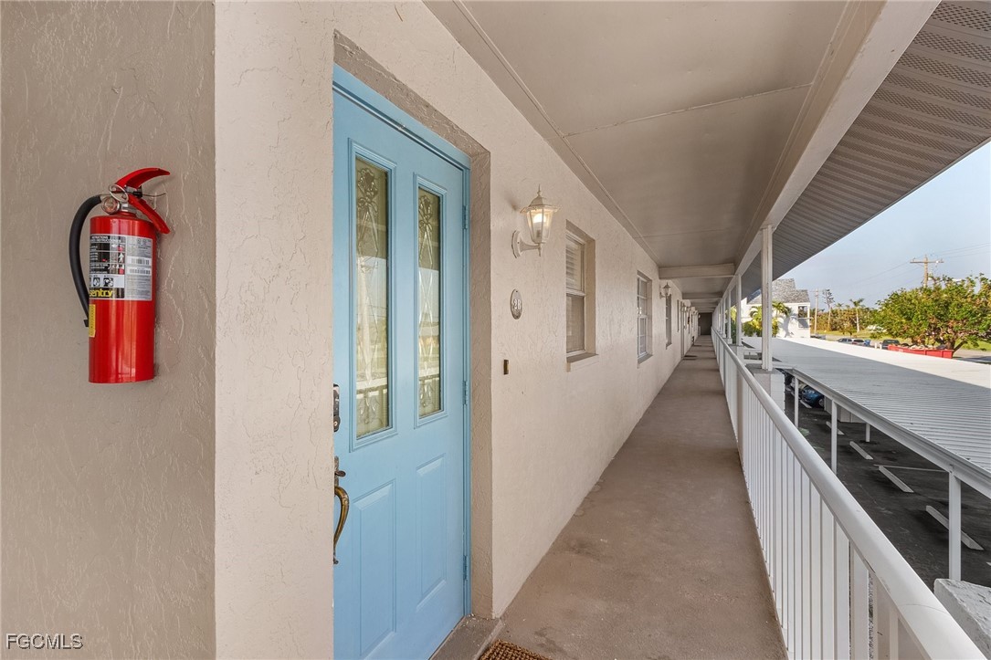 1120 Southeast 46th Street, Unit 2B Cape Coral, FL 33904 - Photo 2 of 26 a view of a hallway with wooden floor and staircase