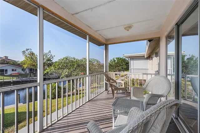 a view of a patio with a dining table and chairs with wooden floor