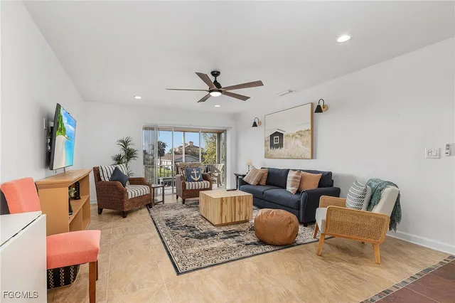 a living room with furniture and a ceiling fan