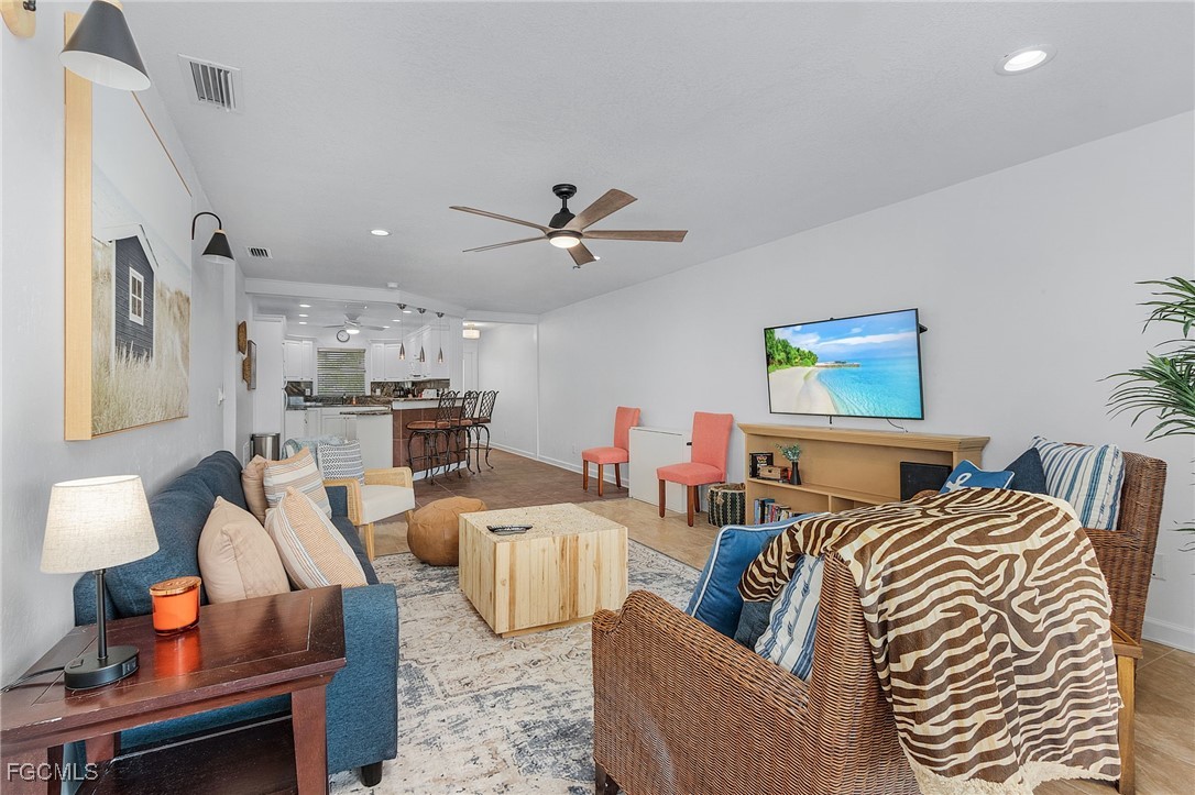 1120 Southeast 46th Street, Unit 2B Cape Coral, FL 33904 - Photo 8 of 26 a living room with furniture kitchen view and a chandelier