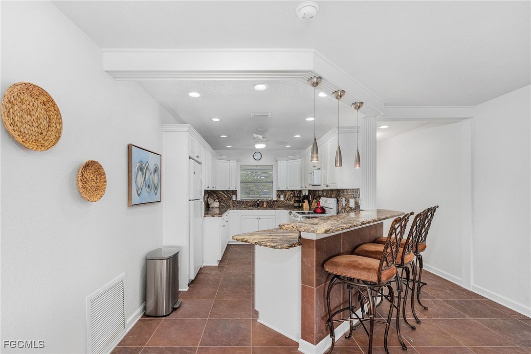 1120 Southeast 46th Street, Unit 2B Cape Coral, FL 33904 - Photo 10 of 26 a kitchen with a table and chairs