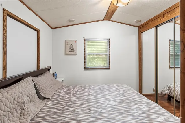 a bedroom with a large bed and a window