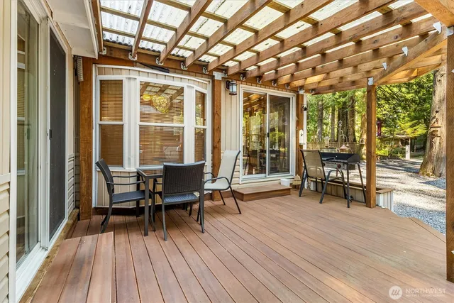 a view of a patio with table and chairs and wooden floor
