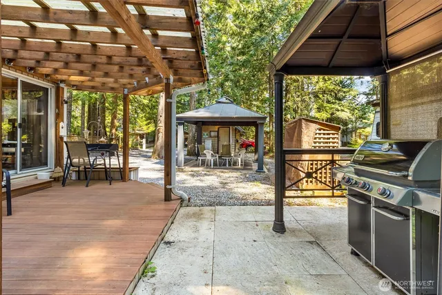a view of a patio with a table and chairs under an umbrella