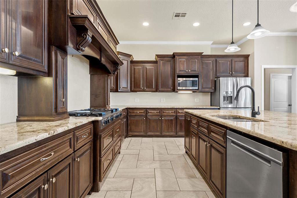 2743 Tokio Road West, TX 76691 - Photo 12 of 40 a kitchen with stainless steel appliances granite countertop a sink and stove
