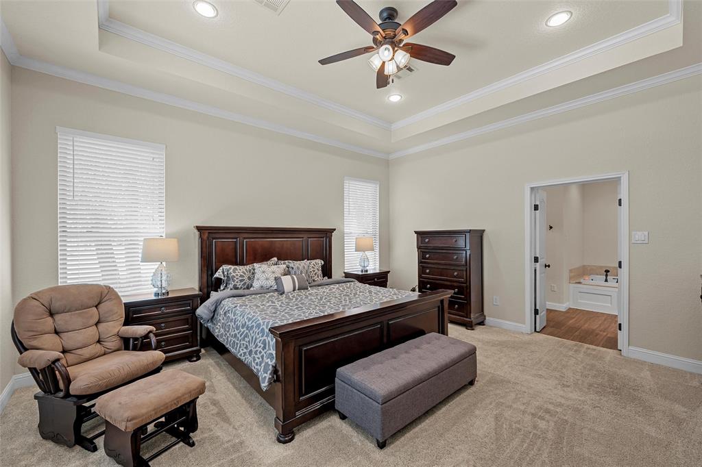 2743 Tokio Road West, TX 76691 - Photo 15 of 40 a bedroom with a bed couches and a flat screen tv