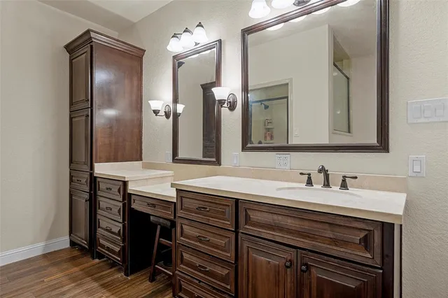 a bathroom with a double vanity sink and a mirror