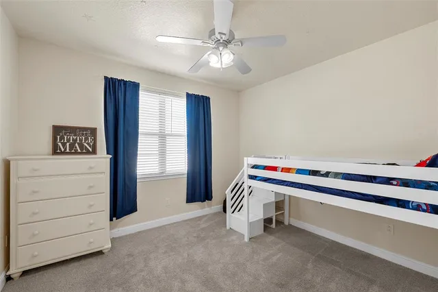 a room with furniture and ceiling fan