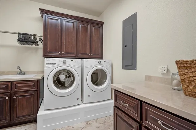 a utility room with sink dryer and washer