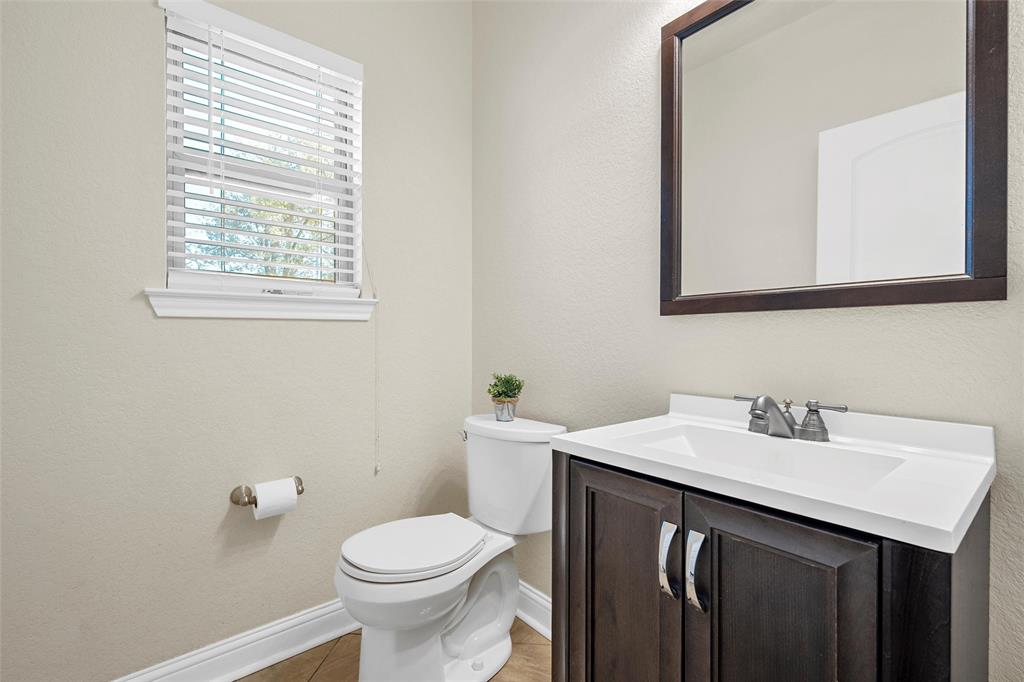 2743 Tokio Road West, TX 76691 - Photo 26 of 40 a bathroom with a sink a toilet and a mirror
