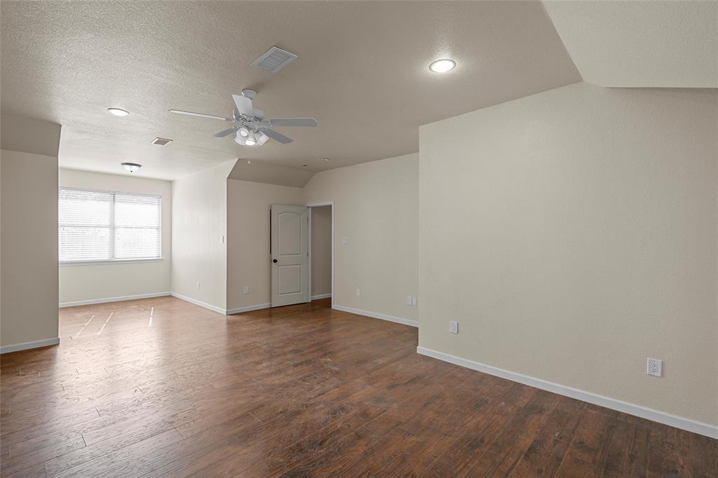 2743 Tokio Road West, TX 76691 - Photo 28 of 40 an empty room with wooden floor and windows