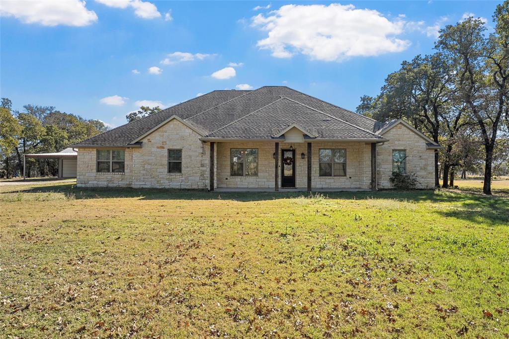 2743 Tokio Road West, TX 76691 - Photo 3 of 40 a front view of a house with a garden