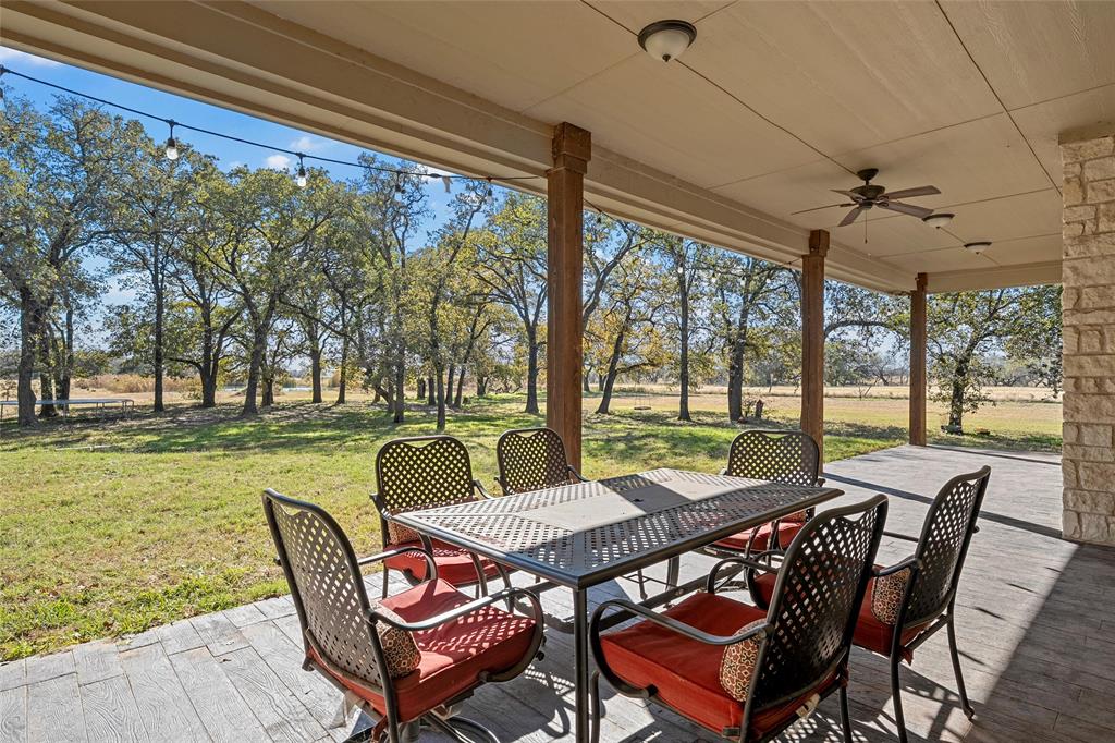 2743 Tokio Road West, TX 76691 - Photo 31 of 40 a view of a patio with a table chairs and a backyard