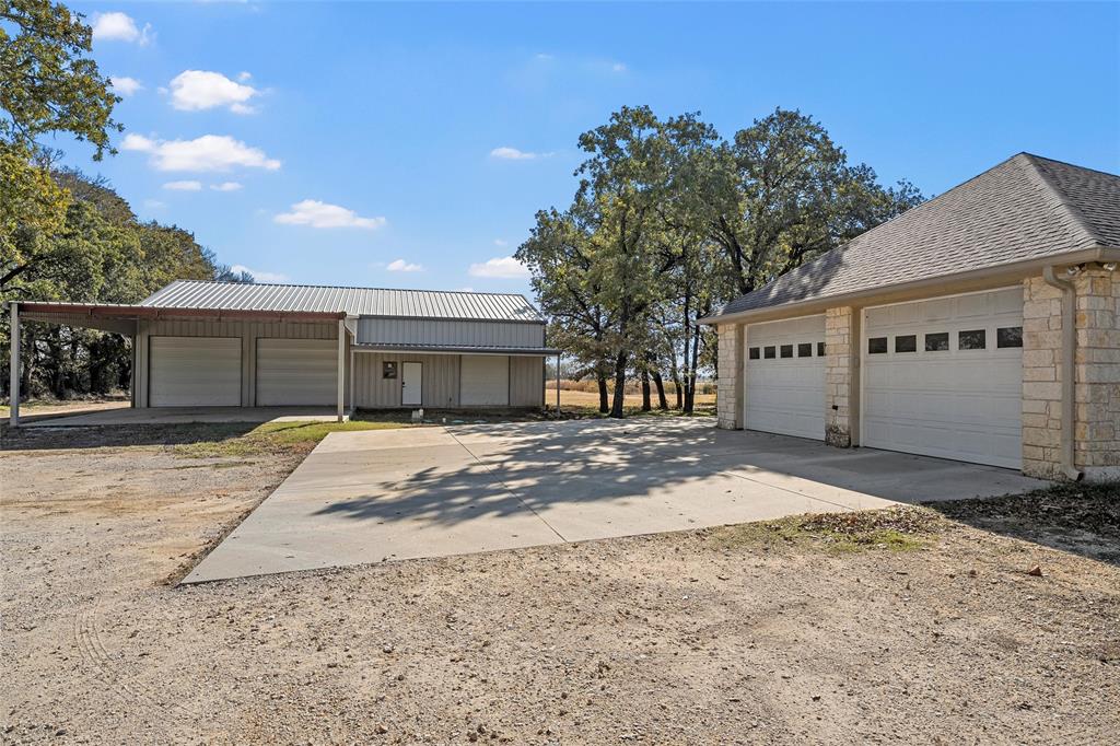 2743 Tokio Road West, TX 76691 - Photo 32 of 40 a view of a house with a yard and covered with trees