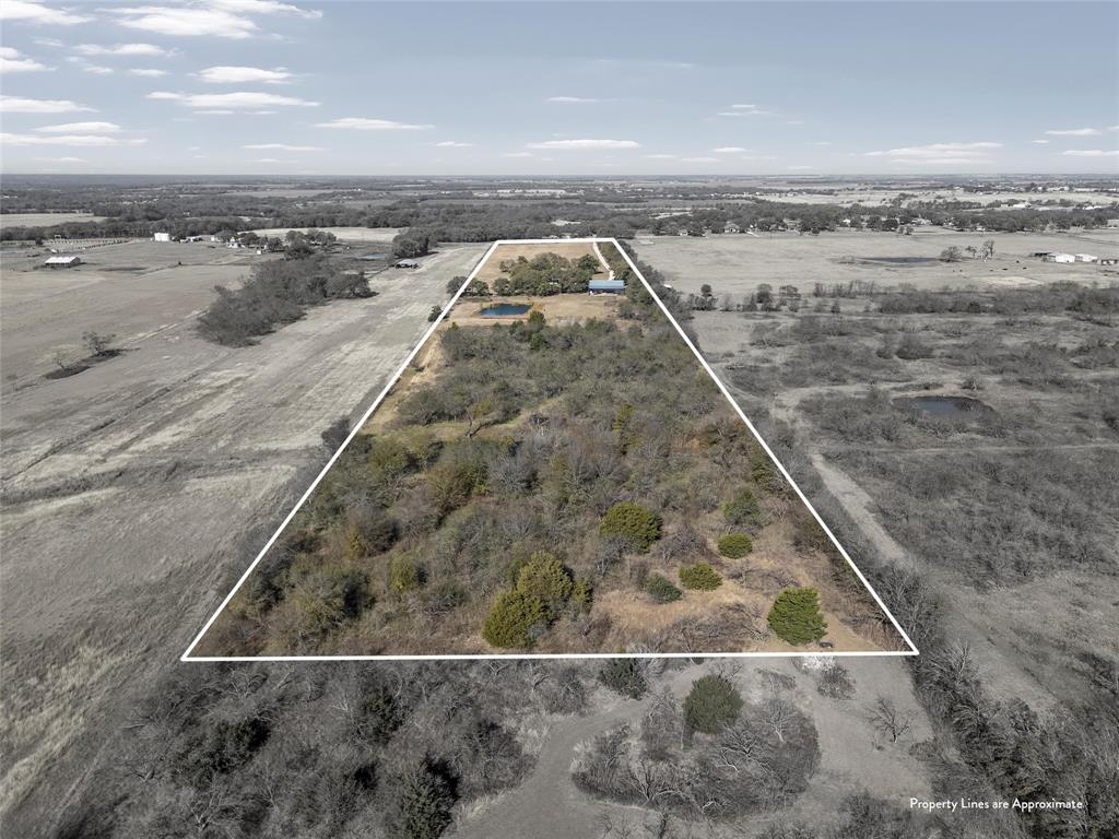 2743 Tokio Road West, TX 76691 - Photo 4 of 40 a view of a dry yard with wooden fence