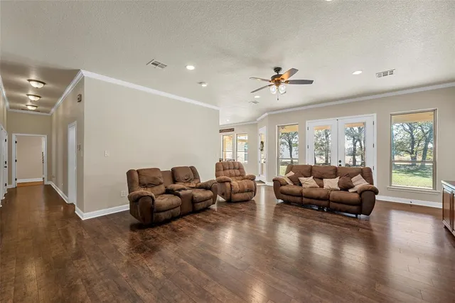 a living room with furniture window and wooden floor