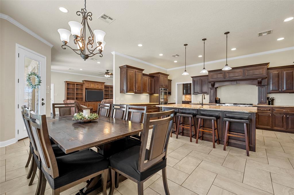2743 Tokio Road West, TX 76691 - Photo 9 of 40 a kitchen with kitchen island a dining table and chairs