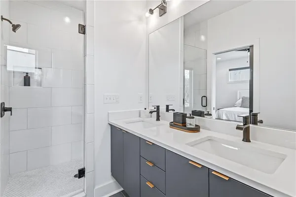 a bathroom with double sink and a mirror