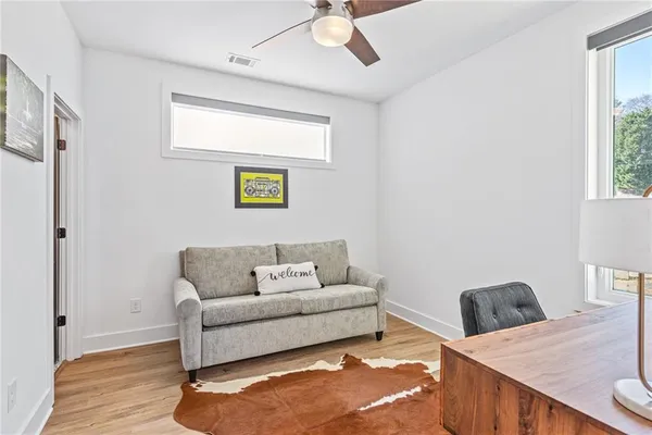 a living room with furniture and a wooden floor