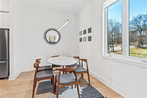 a view of a dining room with furniture and a window