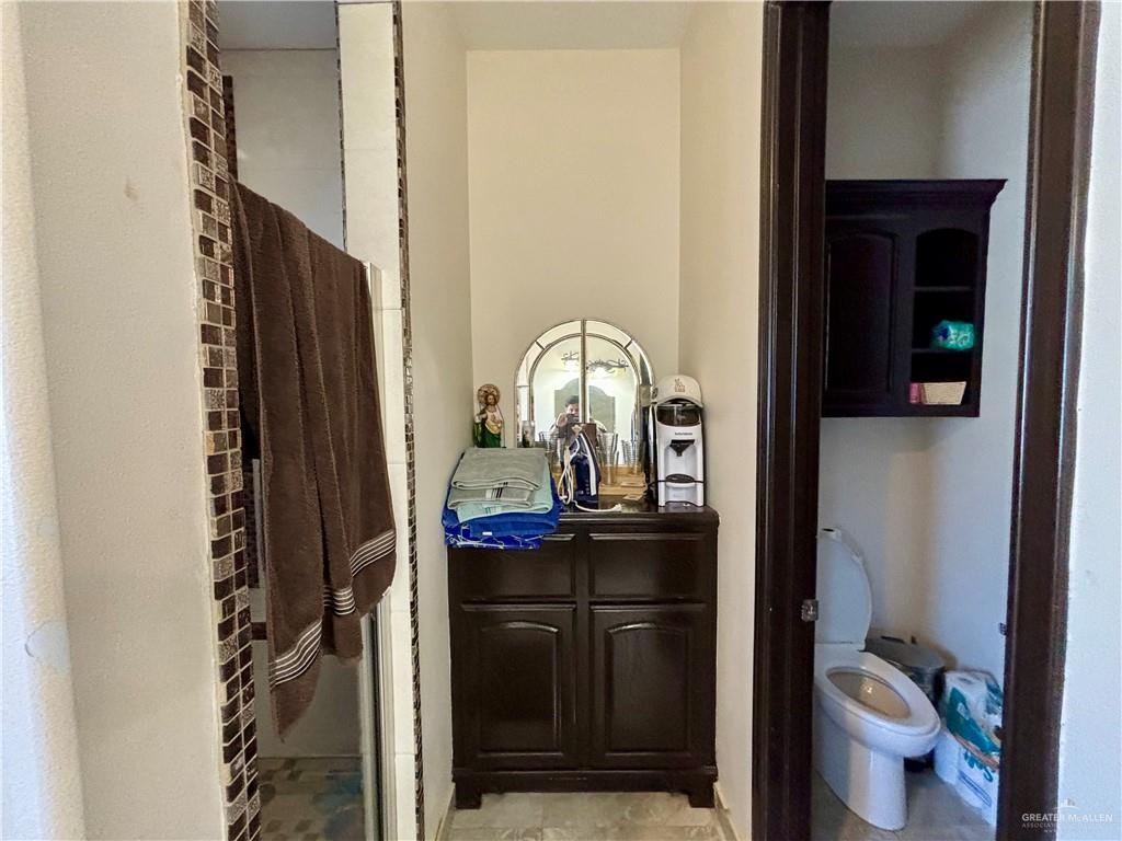 404 South Resplandor Street Mission, TX 78572 - Photo 11 of 19 a view of bathroom with a toilet sink and mirror