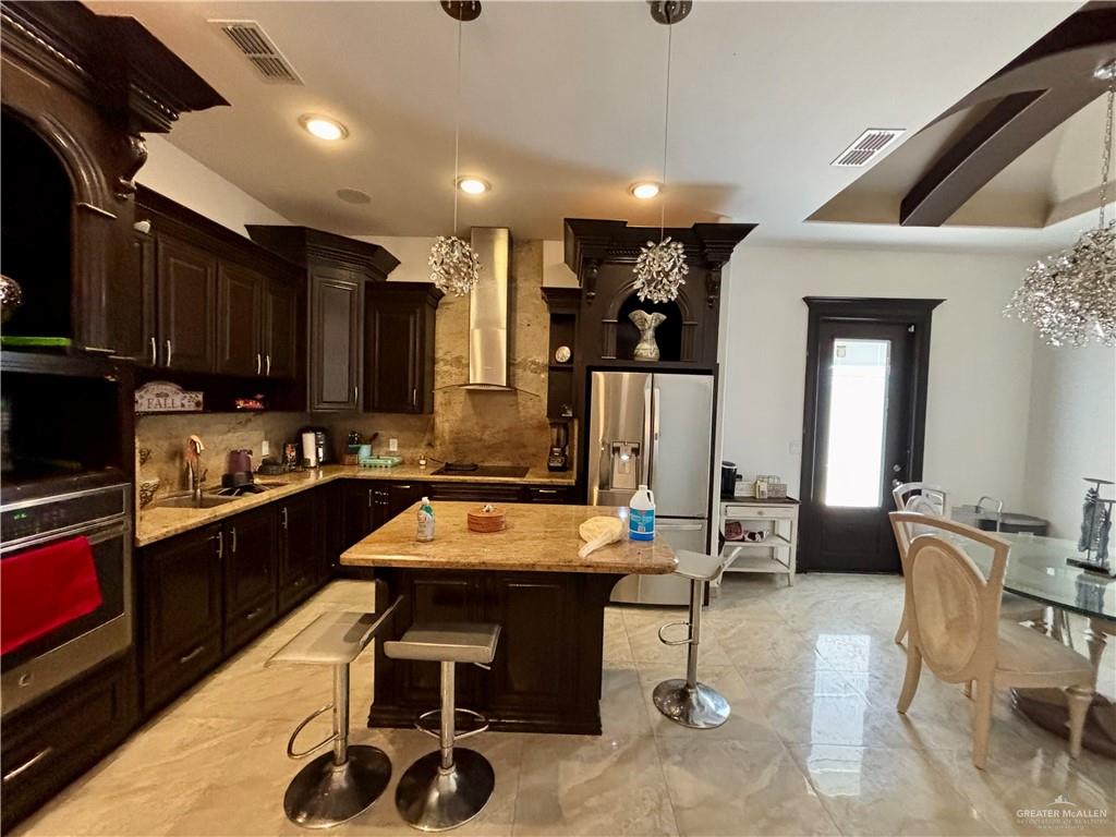 404 South Resplandor Street Mission, TX 78572 - Photo 8 of 19 a kitchen with furniture a sink and a refrigerator
