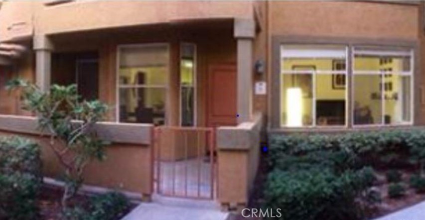 a view of house with patio outdoor seating and plants