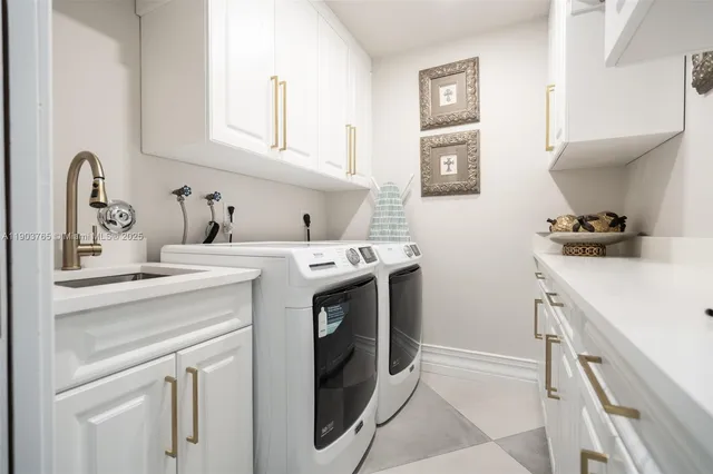 a utility room with sink dryer and washer
