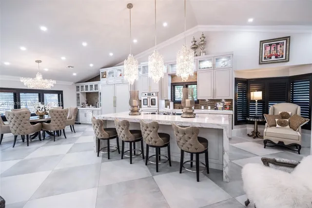 a large dining space with furniture and a large window