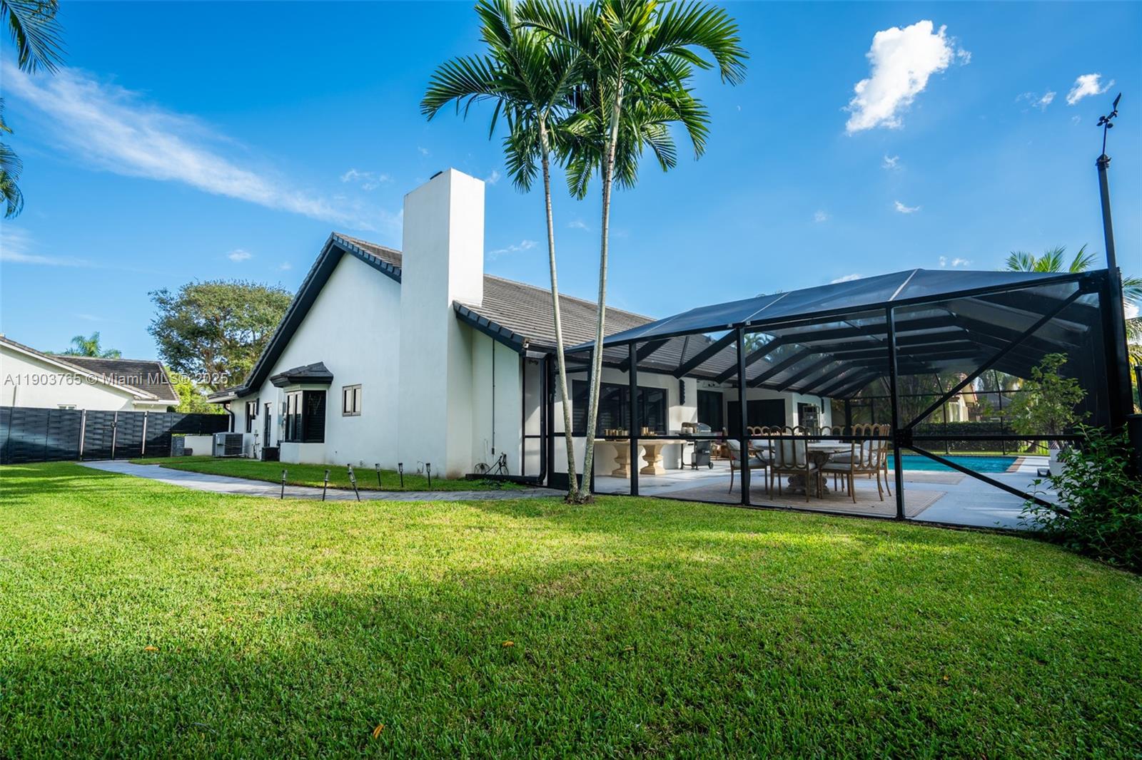 61 Northwest 128th Avenue Plantation, FL 33325 - Photo 22 of 24 a view of a patio with table and chairs under an umbrella