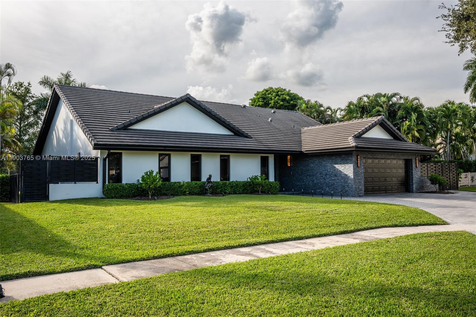61 Northwest 128th Avenue Plantation, FL 33325 - Photo 24 of 24 a front view of a house with a garden and yard