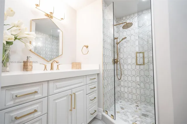 a bathroom with a shower sink and mirror