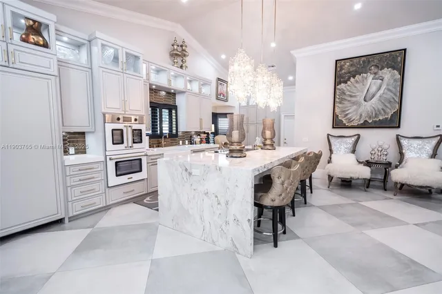 a living room with furniture and view of kitchen