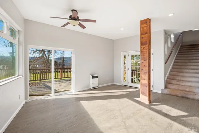 a spacious bathroom with a tub and a large window